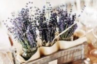 28 rustic centerpiece of a crate and lavender in jars