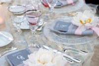 30 light grey tablescape with a ruffled tablecloth and pink glasses and ribbon