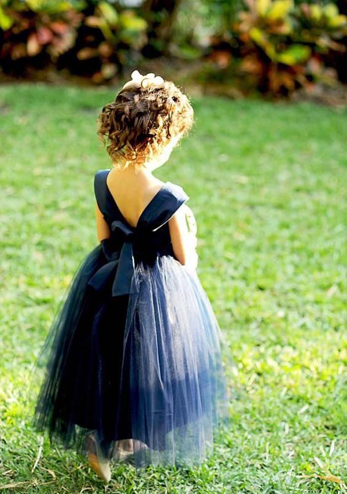 navy dress with a V back and a layered tulle skirt