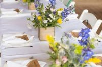 31 wooden boxes with wildflowers as rustic centerpieces