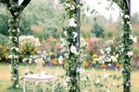34 dark wedding arch all intewoven with greener and white blooms