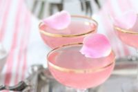 34 pink signature cocktails with petals in gold rim glasses