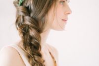 35 curled side swept hairstyle with a floral crown
