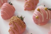 35 pink glazed strawberry with gold ontop