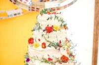 36 multi-tiered wedding cake with red and yellow wildflowers
