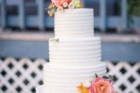 38 white wedding cake with bright fresh flowers