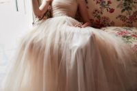 01 Ramona gown in delicate champagne tulle, off-the-shoulder details, a ruched bodice, and voluminous skirt make this gown a romantic’s dream