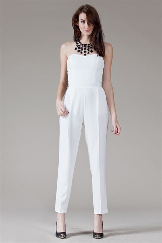 strapless white pantsuit with black heels and a statement necklace