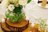 02 wood slices with candle holders and a large vase with white florals