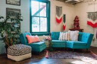 04 The lounge is industrial, with lots of bold colors and some yarn decor