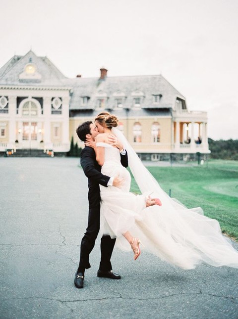 a black tuxedo for the groom and an airy ivory gown and veil for the bride