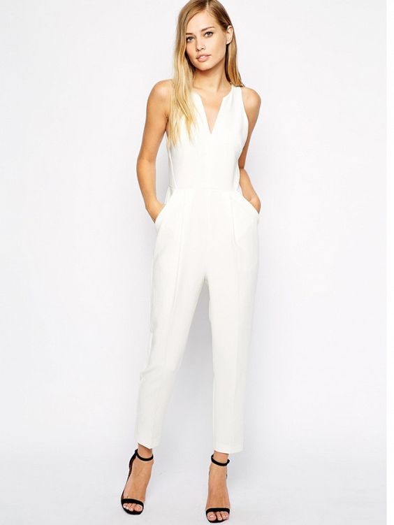 white jumpsuit without sleeves and black heels