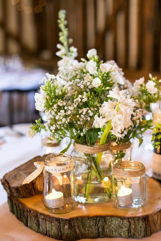 mason jars with ribbons used as candle holders and vases