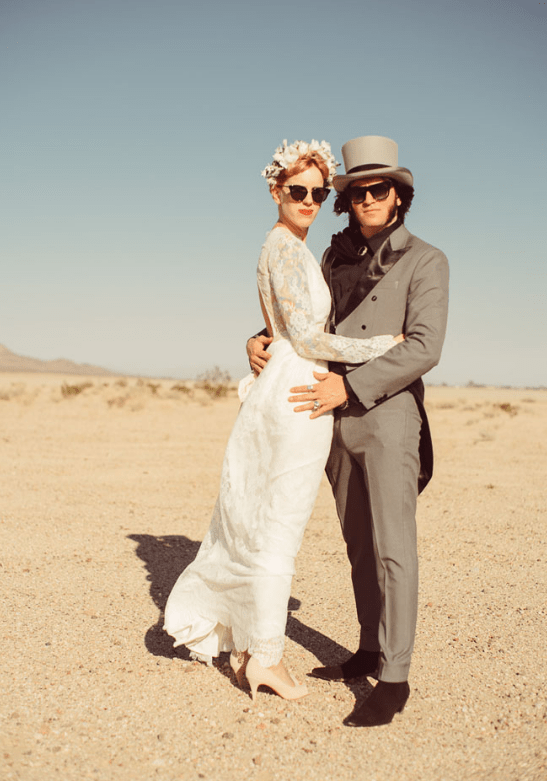 the groom rocked a vintage-inspired grey suit, a top hat and a black shirt