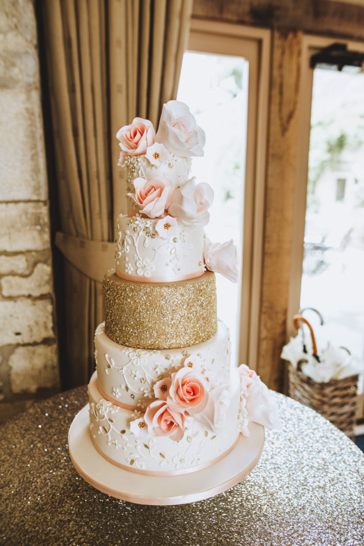 The wedding cake perfectly matched the wedding color scheme with peachy pink and gold glitter