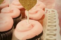 06 chocolate cupcakes with pink glazing and gold glitter heart toppers