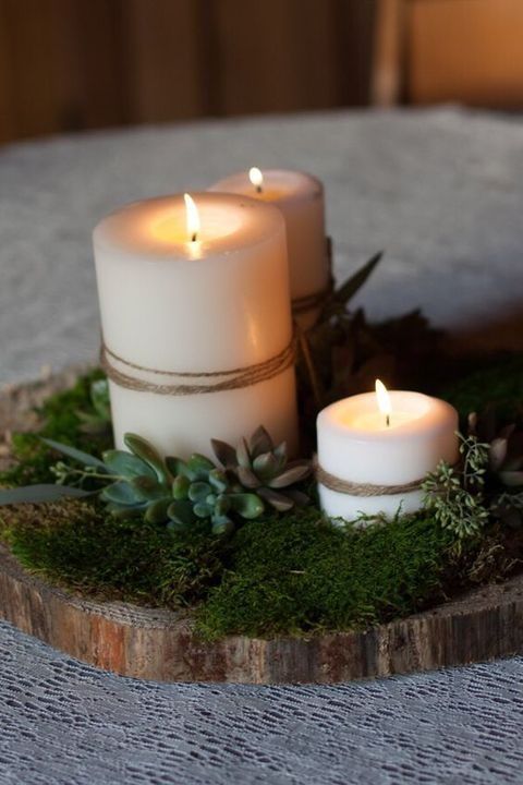 woodland-style centerpiece with moss, succulents and candles wrapped with twine