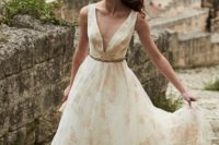 07 Lily gown is with gold and blush embroidered cherry blossoms cascade from shoulder to hem with a soft net overlay for added dimension, a plunging neckline, totally sheer back
