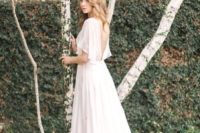 07 airy wedding gown with hald sleeves and a cutout back
