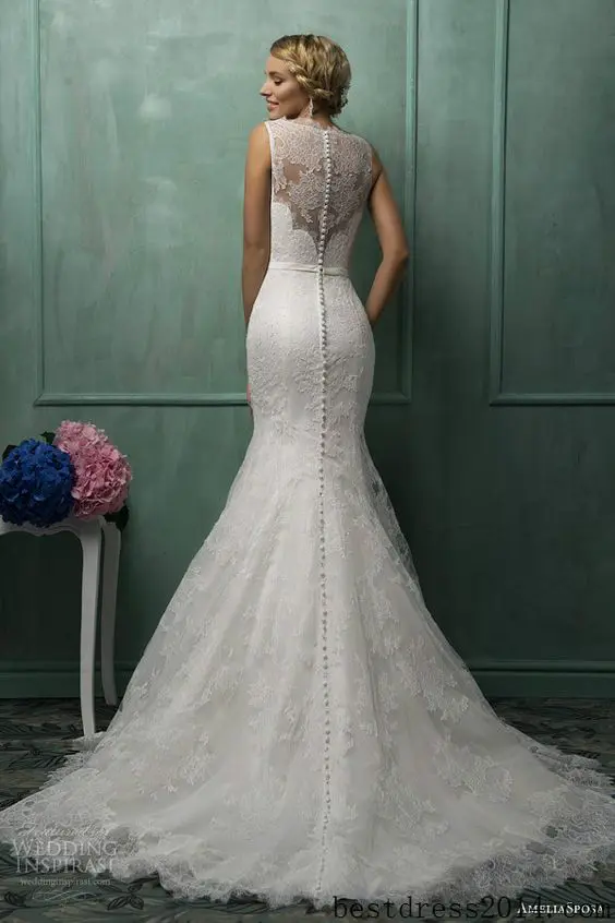 mermaid lace wedding dress with an illusion back and a row of buttons looks flawless