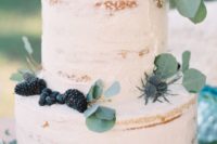 07 two-tiered cake topped with greenery, blackberries and thistles