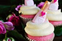 08 pink champagne cupcakes topped with bottle candies