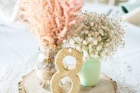 08 wood slice with a glitter table number, mason jars with flowers