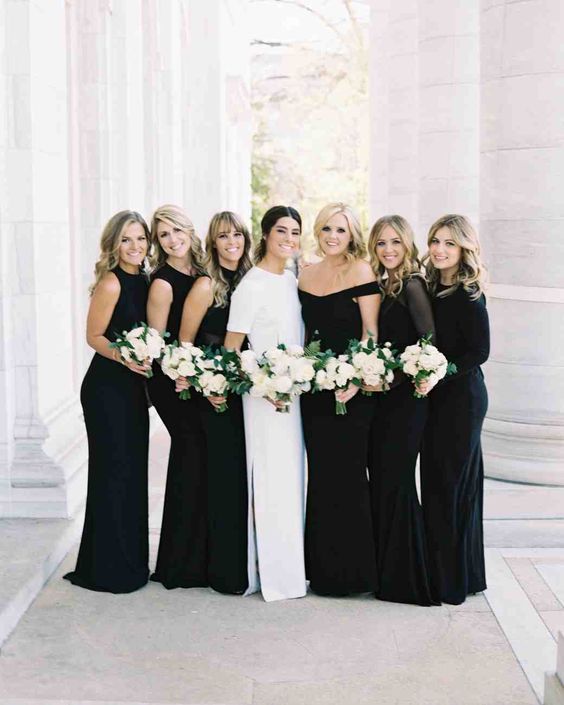 mismatched black bridesmaids' maxi dresses and a modern bride in crispy white