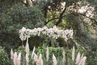 09 wedding arch with white flowers surrounded with pampas and herbs