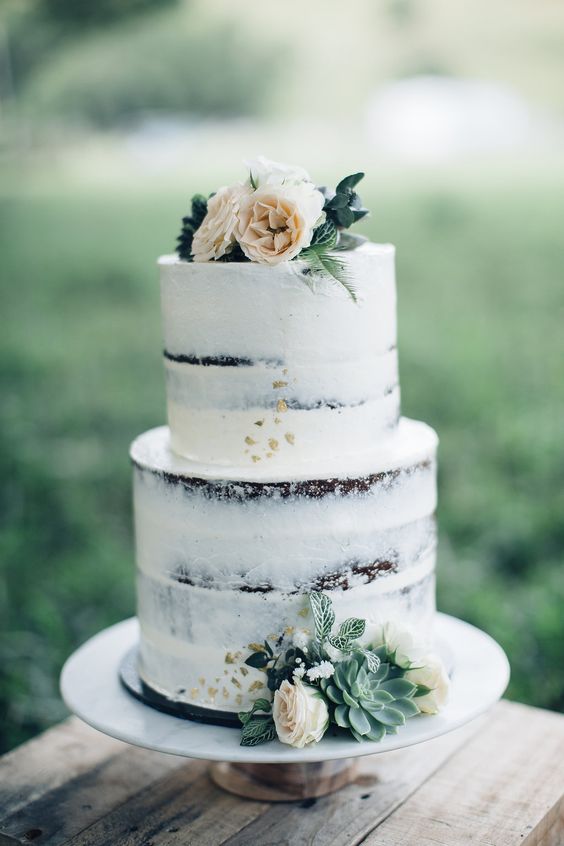 beautiful semi naked cake with succulents and peach-colored flowers