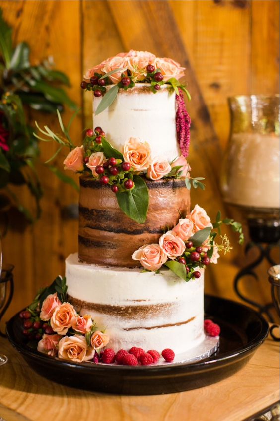 semi naked chocolate vanilla wedding cake  with roses and raspberries