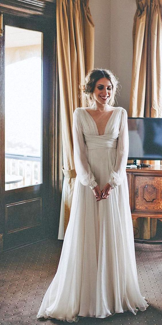 vintage-inspired long-sleeve wedding dress with a plunging neckline