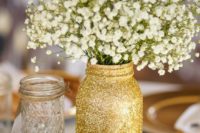 11 woodland centerpiece with a glitter mason jar, wood piece candle holder and flowers