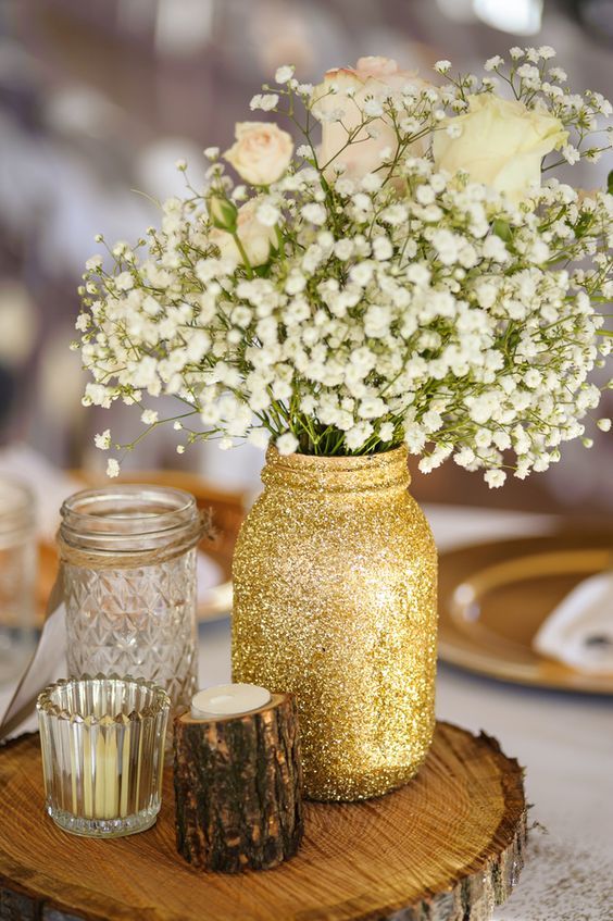 woodland centerpiece with a glitter mason jar, wood piece candle holder and flowers