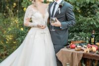 12 The bride was wearing an illusion plunging neckline wedding dress with long sleeves