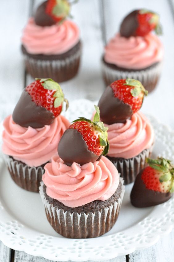 chocolate cupcakes with pink glazing and strawberries