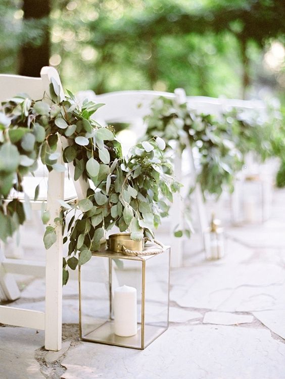 eucalyptus garlands and lanterns for decorating the aisle