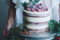 15 semi naked wedidng cake with sugared berries, evergreens and a pinecone