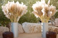 15 wedding altar with a boho rug, leather ottomans and pampas in galvanized urns