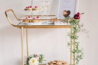 16 brass dessert cart with fresh greenery, champagne and an art piece