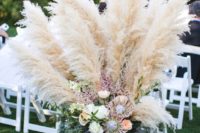 17 an antique urn with pampas grass and flowers