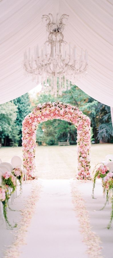 super lush pink floral wedding arch for delicate wedding decor