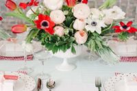 17 white table with red stripes and a red and white floral centerpiece
