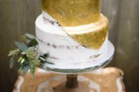 18 metallic gold half naked wedding cake with eucalyptus and a rose