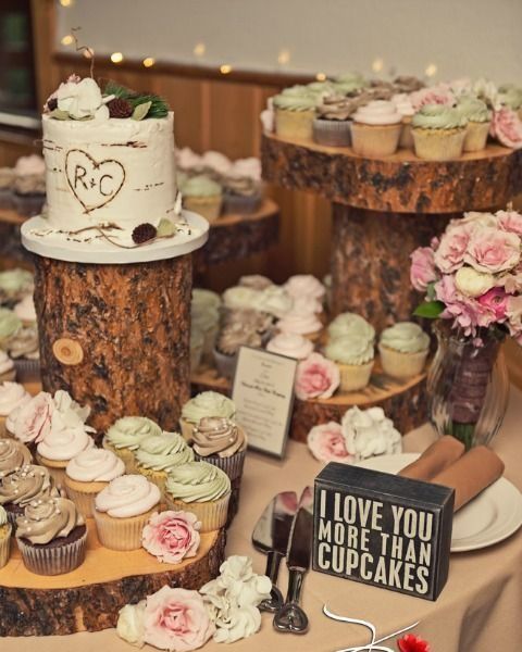 wood slice dessert bar with caupcakes and cakes