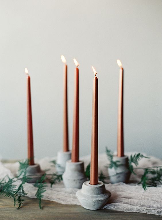 round concrete candle holders with copper candles