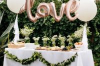 21 outdoor dessert table with pink balloons and greenery