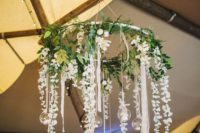 23 greenery and white flowers on a hoop as a wedding chandelier