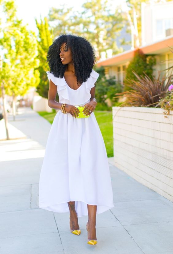 high low midi dress with a ruffle neckline and neon yellow shoes and a clutch