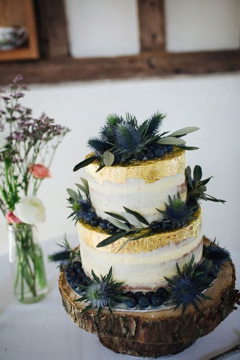 two tier semi naked cake decorated with gold leaf, blueberries and thistles